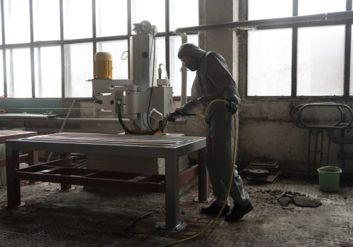 full-shot-man-spraying-powder-paint-from-gun